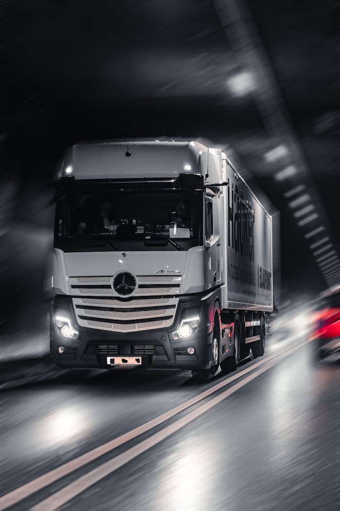pexels-photo-20097991 Mercedes-Benz Actros truck speeding through a city tunnel, capturing urban motion and energy.